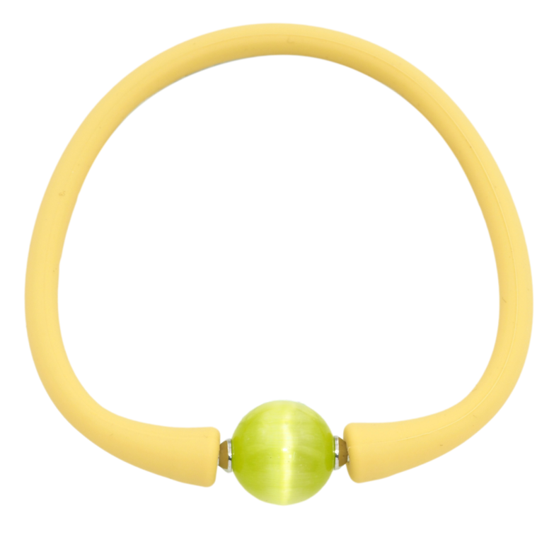 Браслет Xuping Родій Жовтий каучуковий шнур з салатовою намистиною розмір 17.5см х 4мм; ø 12мм фото №1 Браслет Xuping Родій Жовтий каучуковий шнур з салатовою намистиною розмір 17.5см х 4мм; ø 12мм фото №1